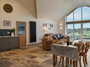 a living room with a table and a couch at Branwen in Llanfachraeth