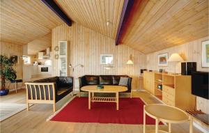 a living room with a couch and a table at Cozy Home In Allinge With Sauna in Allinge