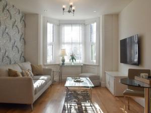 a living room with a couch and a table at Sandend in Lytham St Annes