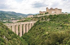 a bridge on a hill with a castle in the background at Roselli in Roselli