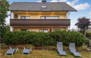 three lawn chairs sitting in front of a house at Nice Apartment In Medebach-ddinghausen With Wifi in Medebach