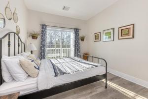 a bedroom with a bed and a window at Beachside Waterview 2Br Condo w/ Pool in Greenport in Greenport
