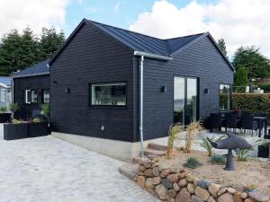 a black house with a black roof at Holiday home Skårup Fyn II in Mægård