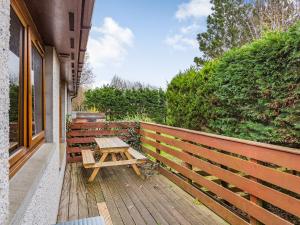 a picnic table sitting on a wooden deck at Church Court Cottage - Uk39009 in Halkirk