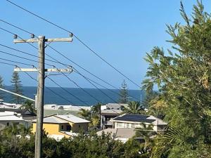 a view of a city with houses and the ocean at Ocean view apartment! 300m to beach. Pet friendly. in Alexandra Headland