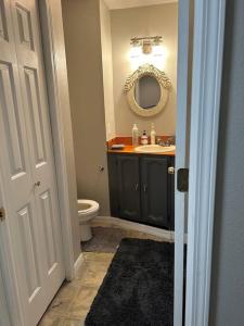 a bathroom with a sink and a toilet and a mirror at Fun Country Living in Dover