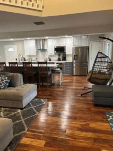a living room with a couch and a kitchen at Fun Country Living in Dover