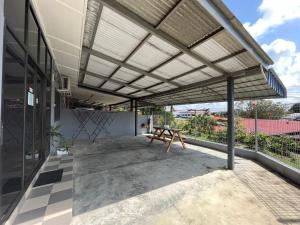 awning over a patio with a picnic table on a building at Aqua Shelter in Mersing