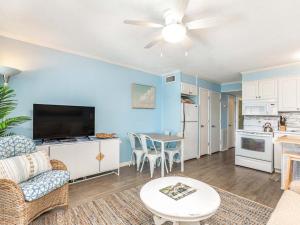 a living room with a couch and a table at Beach Racquet A315 in Tybee Island