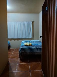 een slaapkamer met een bed op een tegelvloer bij Hotel D Silva in Tochimilco