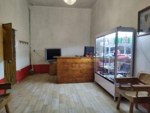 a room with a refrigerator and a tv in it at Hotel D Silva in Tochimilco