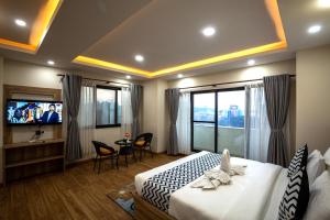 a hotel room with a bed and a television at Hotel Travel INN in Kathmandu