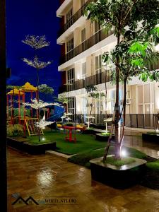 a park with a playground in front of a building at White Studio Group Surabaya - WS 821 at Amega Crown Residence in Tambakoso