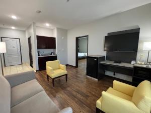 a living room with a couch and a tv at La Quinta by Wyndham Allen at The Village in Allen