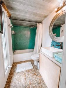 a bathroom with a tub and a toilet and a sink at Cute Guest Suite in Kailua with AC!!! in Kailua
