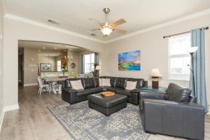 a living room with a couch and a table at SouthernVilla Ticket to Paradise in Palm Coast