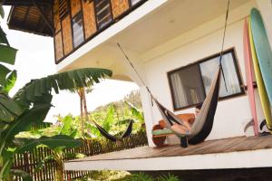 a couple of hammocks on a porch of a house at Pacifico Surf Bayay 
