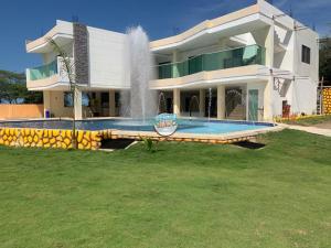 a large house with a fountain in front of it at Special Life Beach in Tubará