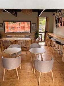 a restaurant with tables and chairs in a room at Domay's Homestay ( Main) 