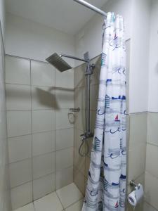 uma casa de banho com chuveiro e cortina de chuveiro em Field Residences Bldg5 em Manila