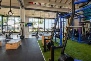 a gym with a bunch of equipment in a room at BALLITO HILLS, 1 bedroom apartment in Ballito