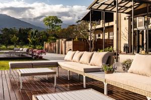 a patio with couches and tables on a house at W Starry Villa in Ruisui