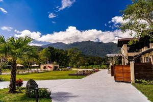 a walkway in a park with a mountain in the background at W Starry Villa in Ruisui