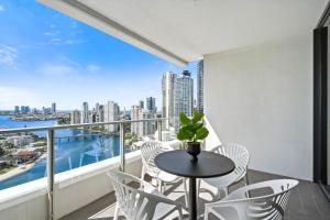 a balcony with a table and chairs and a view of the city at Avalon Apartments - Wow Stay in Gold Coast