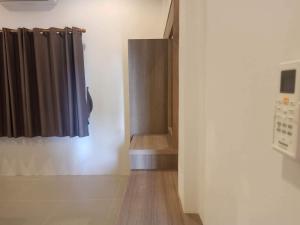un pasillo con una puerta y una cortina en una habitación en Mac's Bay Resort, en Baan Tai