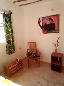 a room with a painting of a man on the wall at Bibi Mrembo Guesthouse in Pingwe