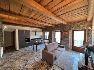 un soggiorno con divano e una cucina di Appartamento completamente ristrutturato a Montecrestese