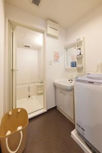 a small bathroom with a sink and a toilet at ZEROSHARE CHIKKO in Osaka