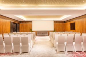 a conference room with white chairs and a screen at Hyatt Centric Soalteemode Kathmandu in Kathmandu +90 photos