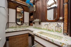 a bathroom with two sinks and a tub with a mirror at Guesthouse Bon in Kyoto