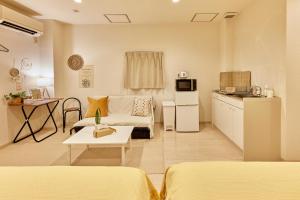 a small living room with a couch and a kitchen at ZEROSHARE CHIKKO in Osaka