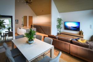 a living room with a couch and a table at Prominence by The Hakuba Collection in Hakuba