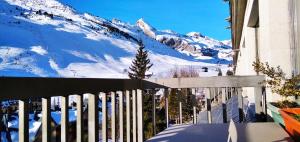 a view of a snow covered mountain from a house at Apartamentos Pirineos Rent in Candanchú