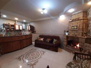 a living room with a couch and a fireplace at House 125a in Dilijan