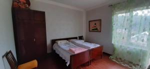 a small bedroom with a bed and a window at House 125a in Dilijan