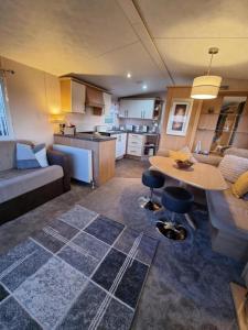 a kitchen and living room with a couch and a table at Bella View - Newquay - White Acres in Newquay