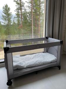 a bed sitting in front of a window at Villa Horihane - Modern Villa with panoramic view in Ivalo