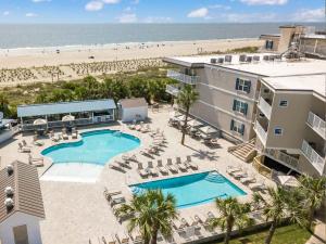 an aerial view of a resort with a swimming pool and the beach at Colony 221 in Tybee Island