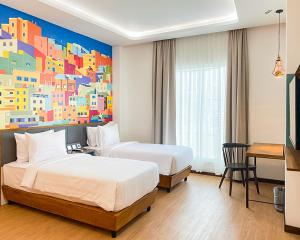 Postel nebo postele na pokoji v ubytování Alhambra Hotel Banda Aceh