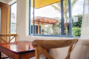 a dining room with a table and a window at Futuna Rocks Motel in Kaikoura