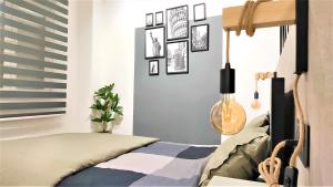 a bedroom with a bed and pictures on the wall at Apartamento María - precioso y tranquilo loft en pleno centro in Murcia