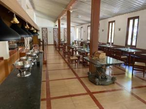 a restaurant with tables and chairs in a room at Zeenath Taj Gardens in Yelagiri