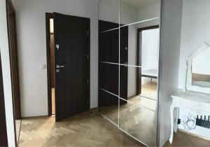 a glass closet in a room with a mirror at Apartamenty Centrum in Augustów