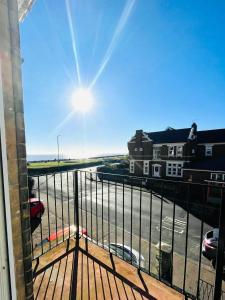 a view from a balcony of a street with cars at Coral House in Gorleston-on-Sea