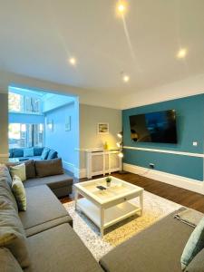 a living room with a couch and a coffee table at Coral House in Gorleston-on-Sea