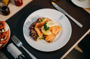 a white plate of food on a table at Seaside 43 in Sankt Peter-Ording